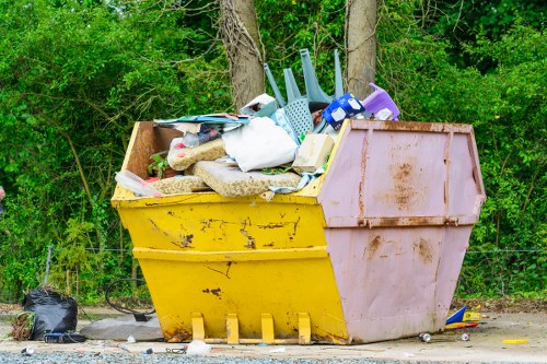 Construction site with waste being cleared by professionals